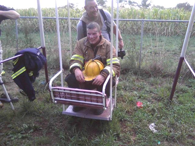 It's resting time after the fire on Keymar Rd. as Firefighter Matt Storey gets a push from Lt. Chris Harris.