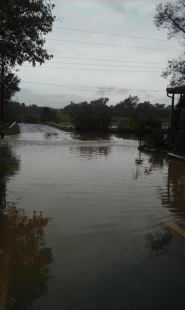 Flooding at Bucher John Rd/Locust Street. The bridge is the only hgh ground here. On the other side, water floods the road as well.